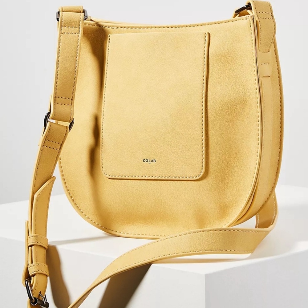 Colab handbag crossbody bag with a curved silhouette and adjustable strap.